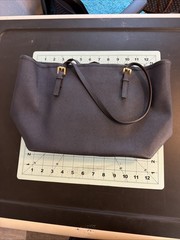 Michael Kors tote features gold-toned hardware distinctive front buckle strap