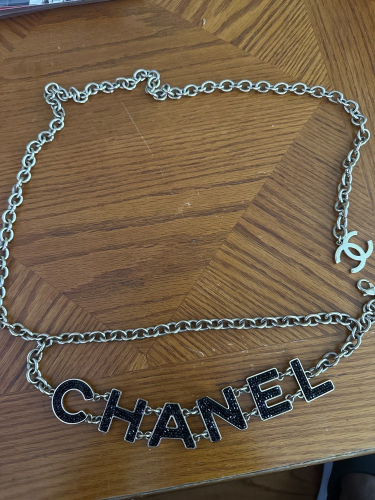 Authentic Chanel gold-tone chain belt featuring black logo letters. Size xs-xl
