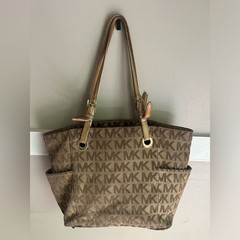 Michael Kors Jet Set tote the brand’s signature monogram canvas & gold hardware