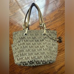 Michael Kors Jet Set tote the brand’s signature monogram canvas & gold hardware