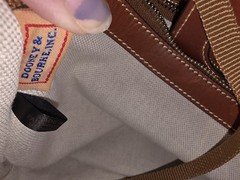 Dooney and Bourke Ostrich Turnlock Flap Handle Tote Black with Brown Trim